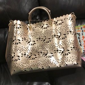 Laser cut metallic rose gold hand bag